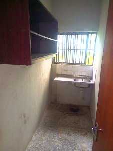 A room and Parlor self contain, terazo, water running, well fenced and gated 4