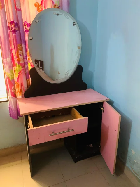 Pink and black dresser and bed frame
