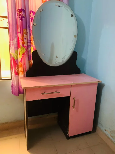 Pink and black dresser and bed frame