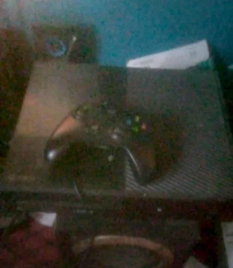 Black Xbox one with one wireless pad and 5 games