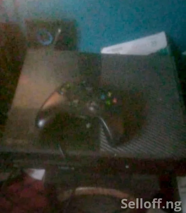 Black Xbox one with one wireless pad and 5 games